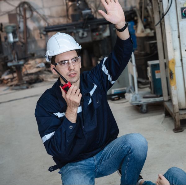 Worker beside factory machinery