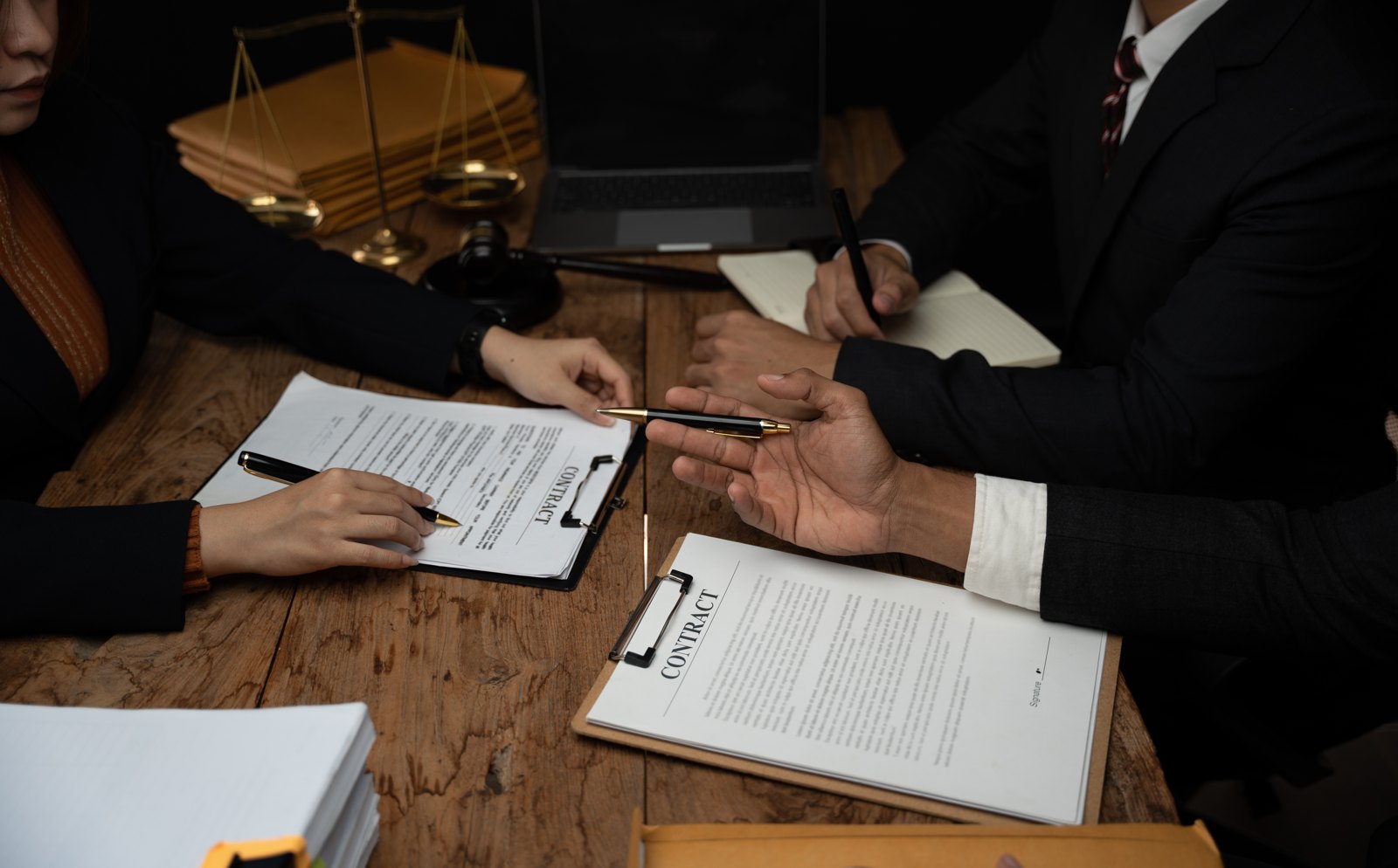 Two professionals reviewing documents across a desk