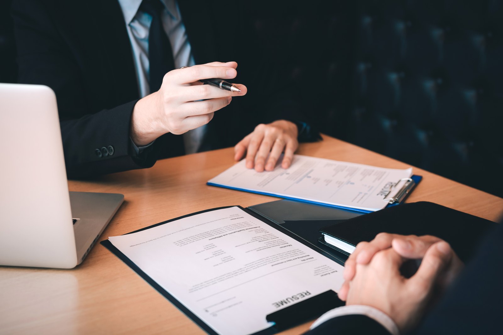 Client and adviser discussing paperwork at a desk