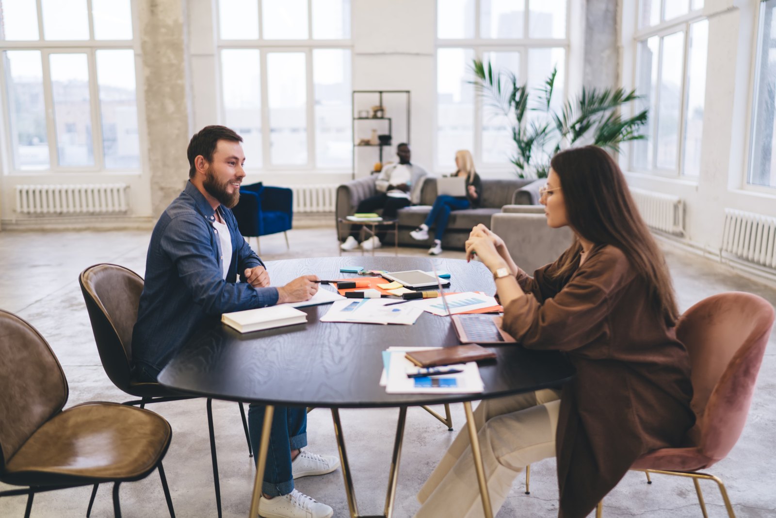 Professionals discussing documents around a meeting table