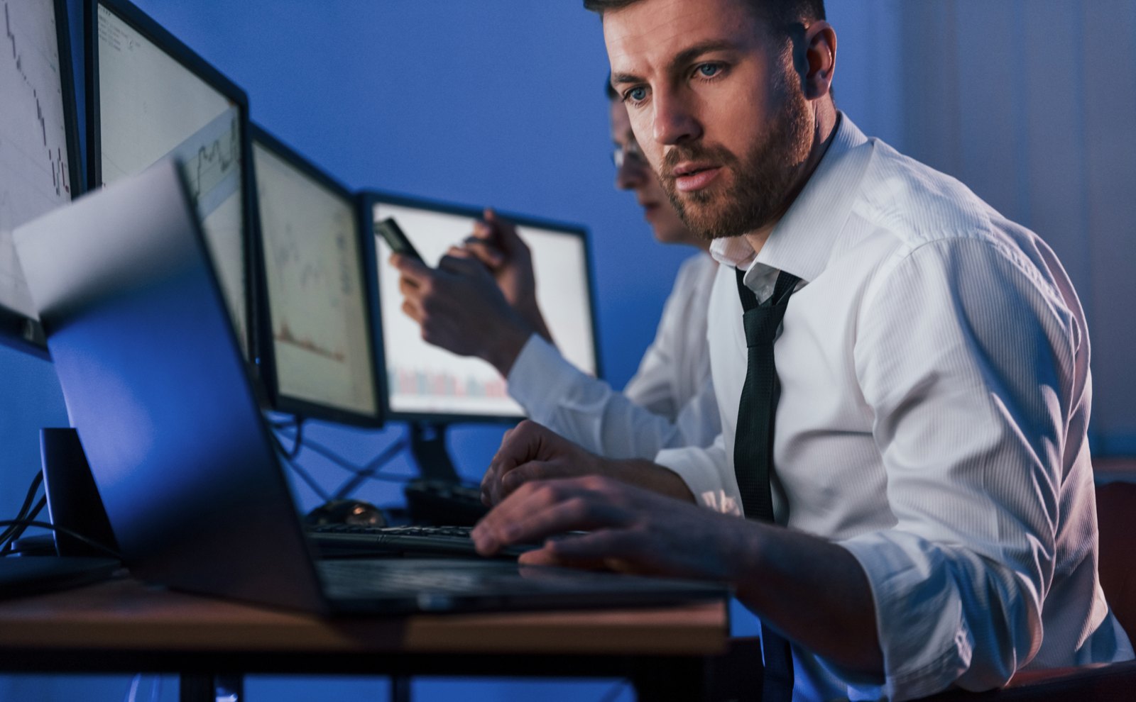 Professional examining information on computer screens